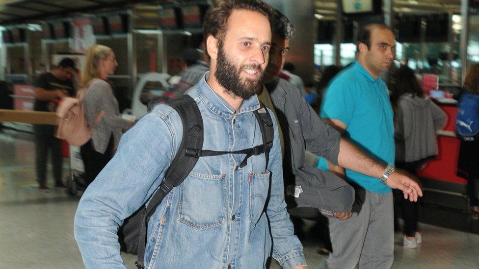 French photographer Mathias Depardon walks at the international departure terminal of Ataturk airport in Istanbul