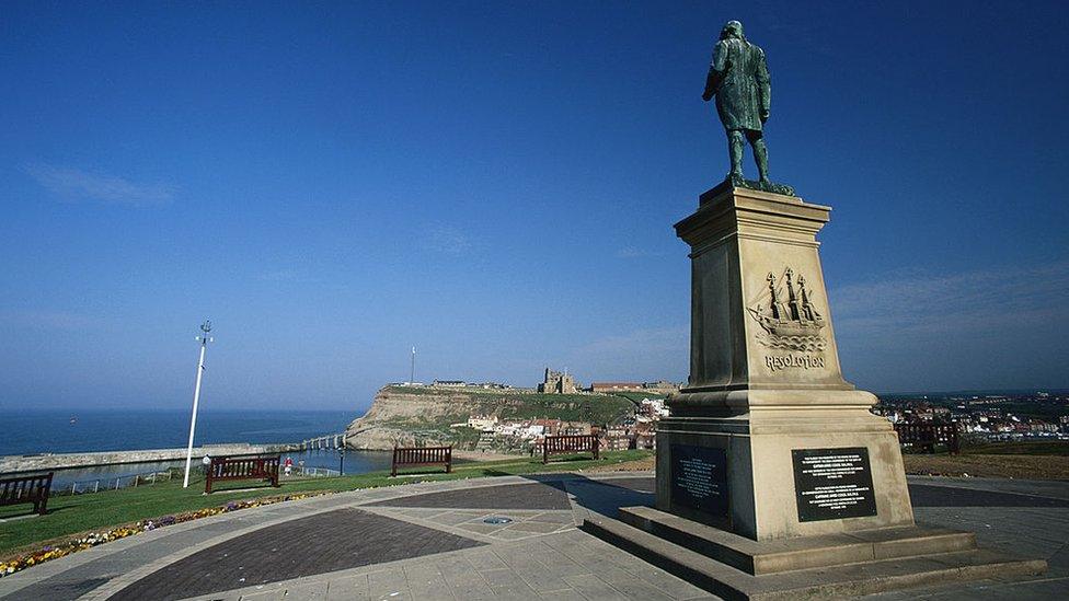 A statue pf Captain Cook looks out from the west cliff of Whitby, Yorkshire.