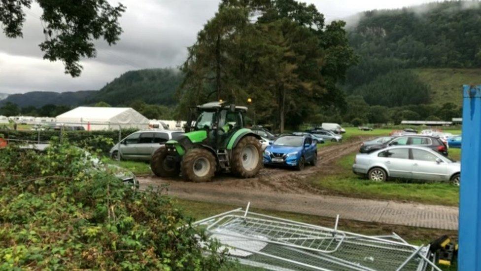 A car being towed by a tractor