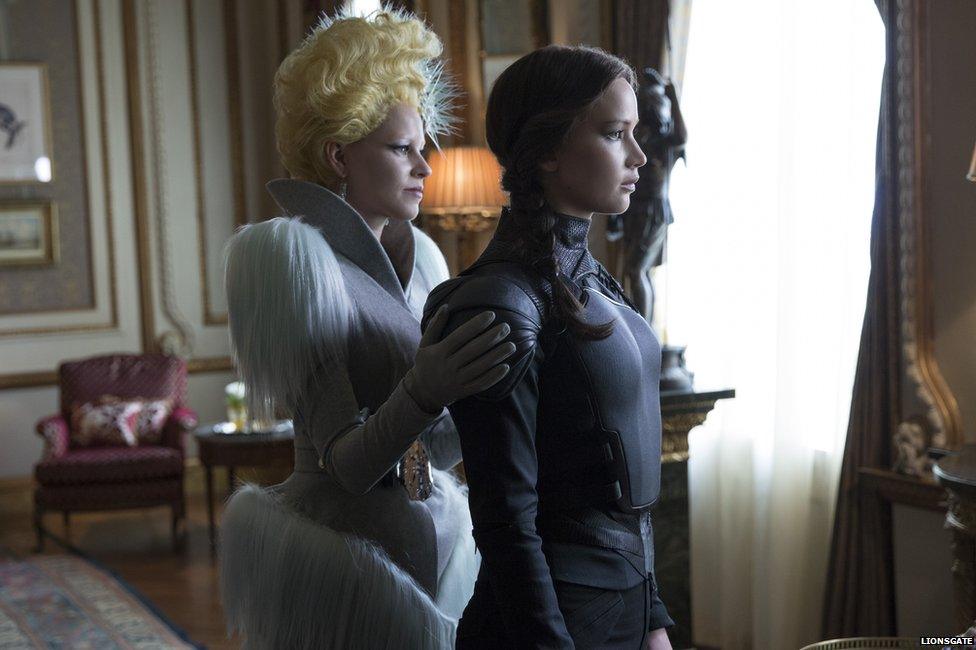 Elizabeth Banks as Effie Trinket and Jennifer Lawrence as Katniss Everdeen