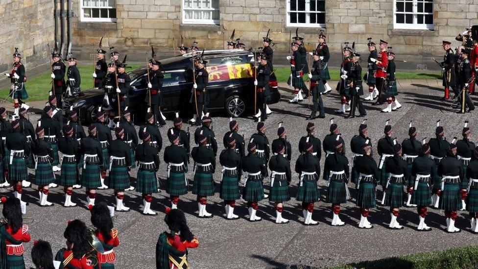 Royal guards follow the Queens' hearse.