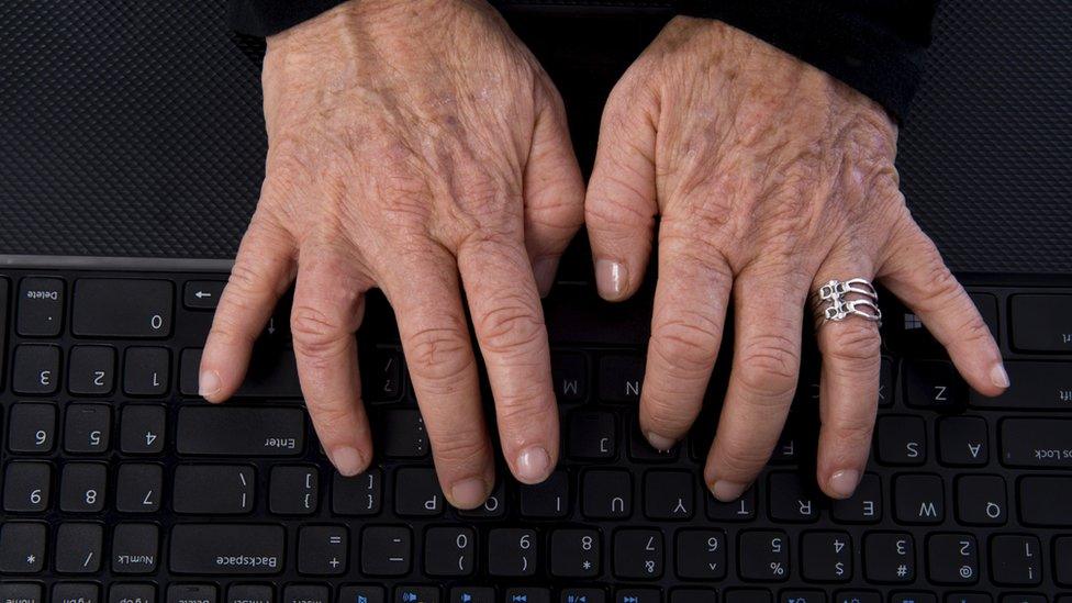 Elderly woman's hands on keyboard