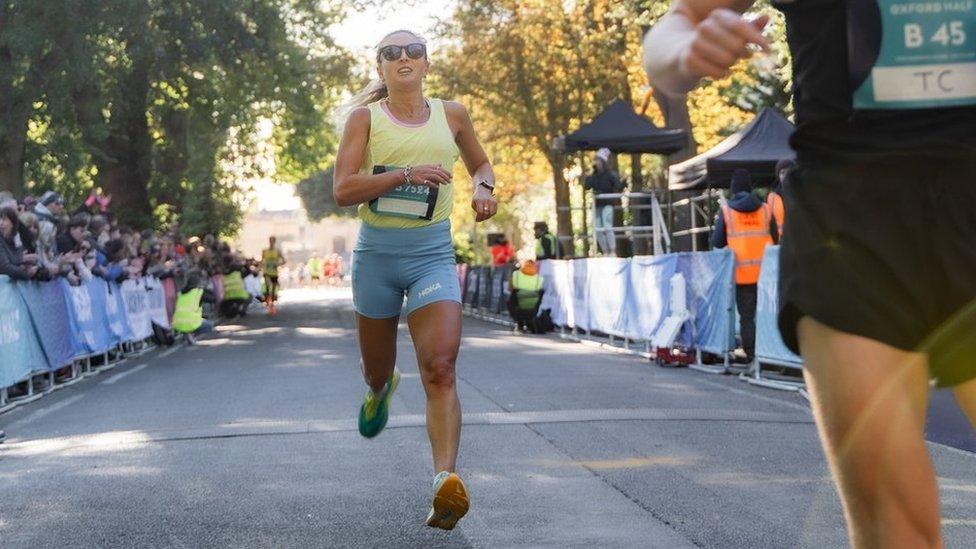 woman crossing finish line at race