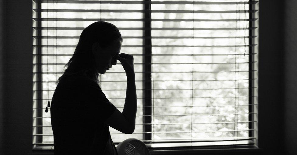 Stock image of woman with head in her hands