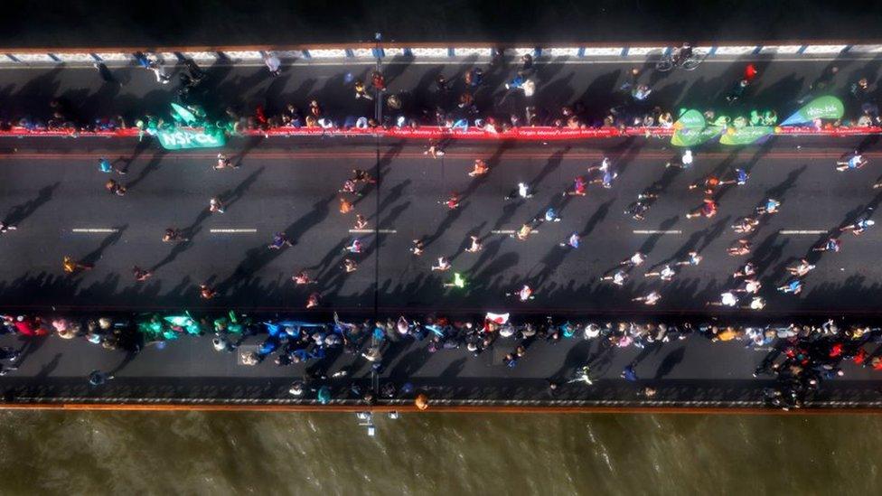 Runners cross over Tower Bridge during the Virgin Money London Marathon.