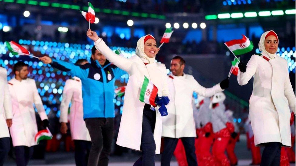 Iran delegates during the opening ceremony for 2018 winter games, waving flags in venue