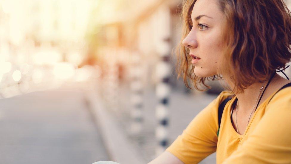 Young women looking across a street