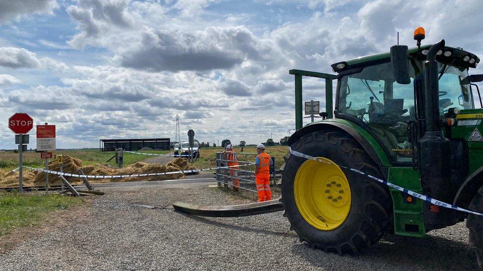 A tractor and freight train collided on a level crossing