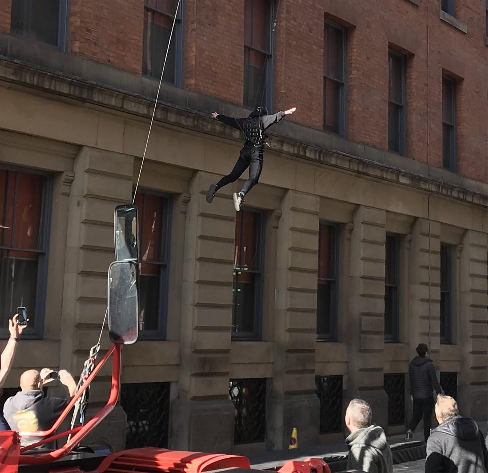 Stuntman hanging from a wire