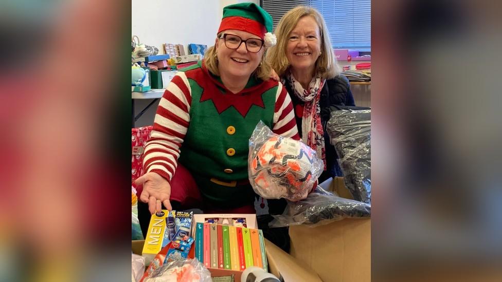 Volunteers wrapping presents for vulnerable children