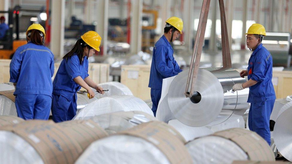 Chinese workers packaging aluminium tapes at an aluminium production plant in Huaibei, east China's Anhui province