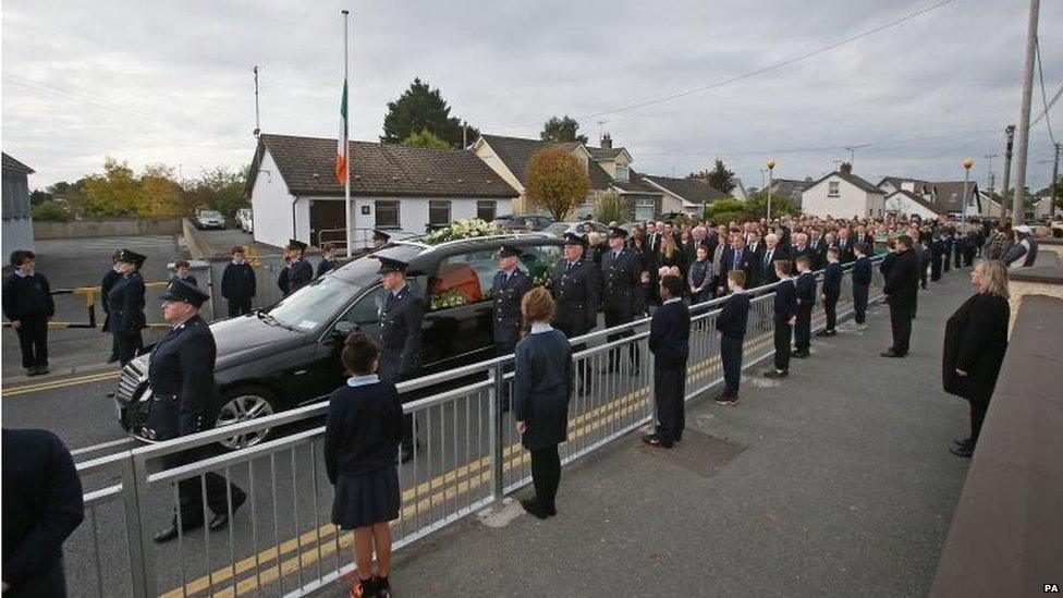 Funeral cortege passes the police station in Blackrock