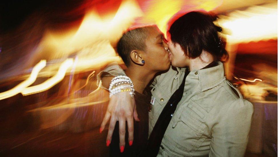 Clubbers kiss as they attend a large dance party at GWK Cultural Park early August 27, 2005 in Jimbaran, Bali, Indonesia.