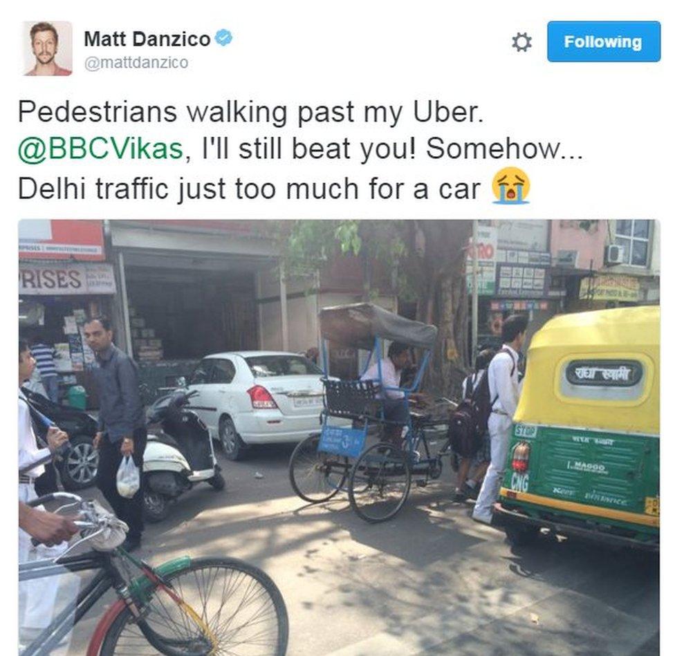 BBC Pop Up's Matt Danzico tweets about his Uber being stuck in traffic. Text reads: "Pedestrians walking past my Uber. @BBCVikas, I'll still beat you! Somehow... Delhi traffic just too much for a car"