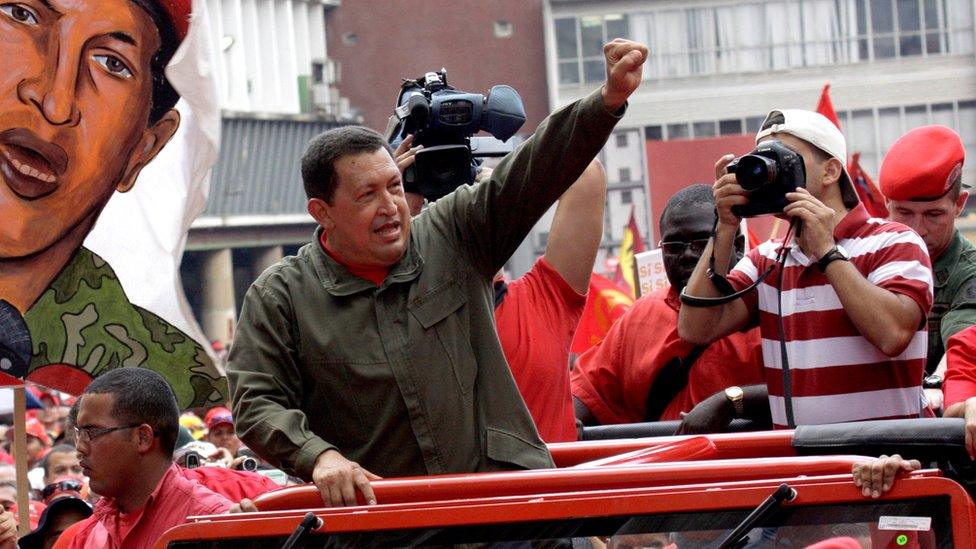 Late Venezuelan president Hugo Chavez gestures to supporters as he arrives to campaign in Caracas on 23 January 2009