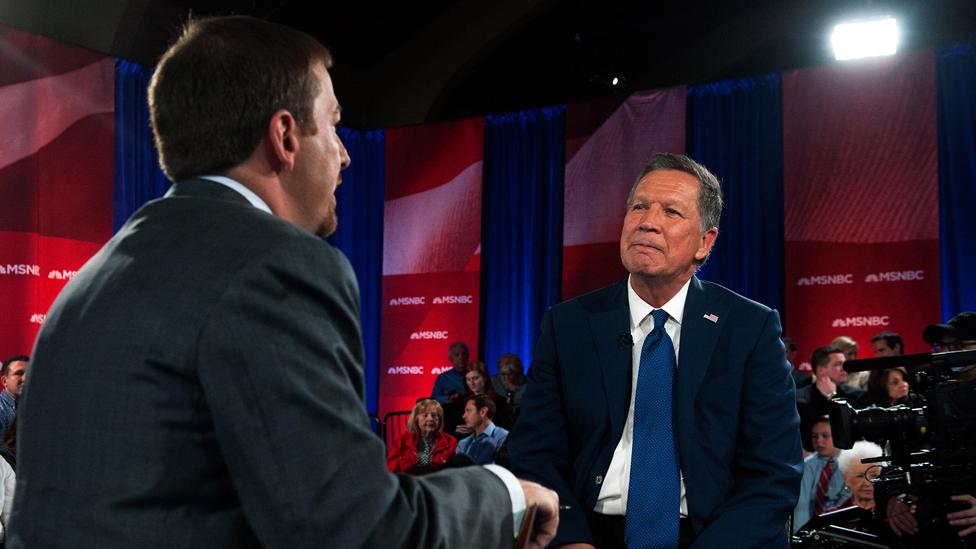 MSNBC's Chuck Todd (left) and GOP Presidential Candidate John Kasich (right) speak with the crowd during a commercial break in a town hall meeting at St. Helen's Roman Catholic Church on March 30, 2016