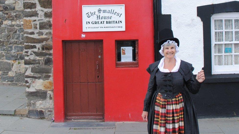 Amanda Whitehead outside the UK's smallest house, on the quayside at Conwy