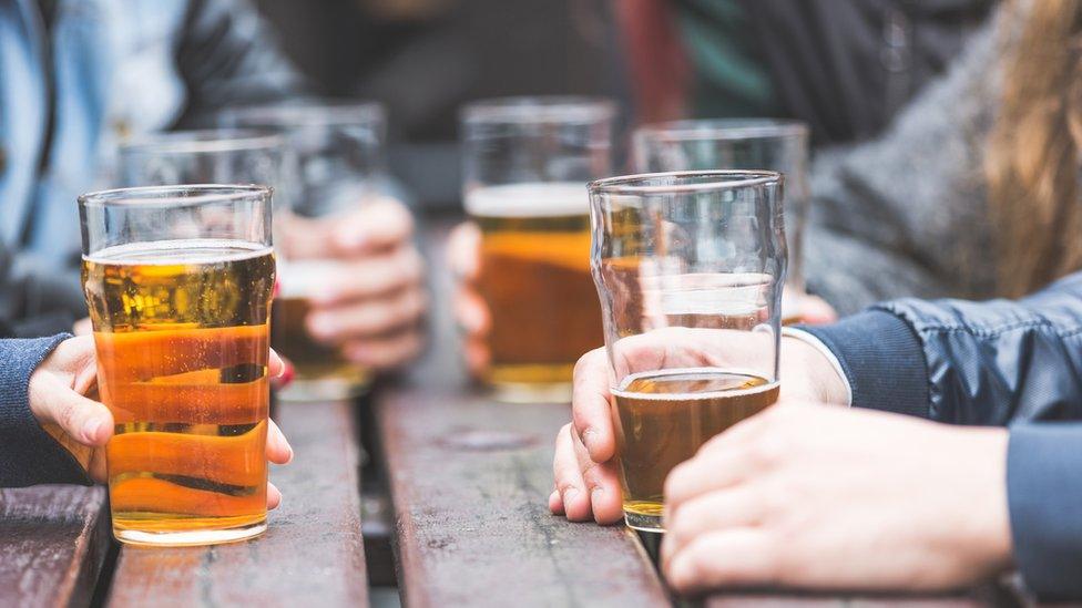 Hands holding beer glasses