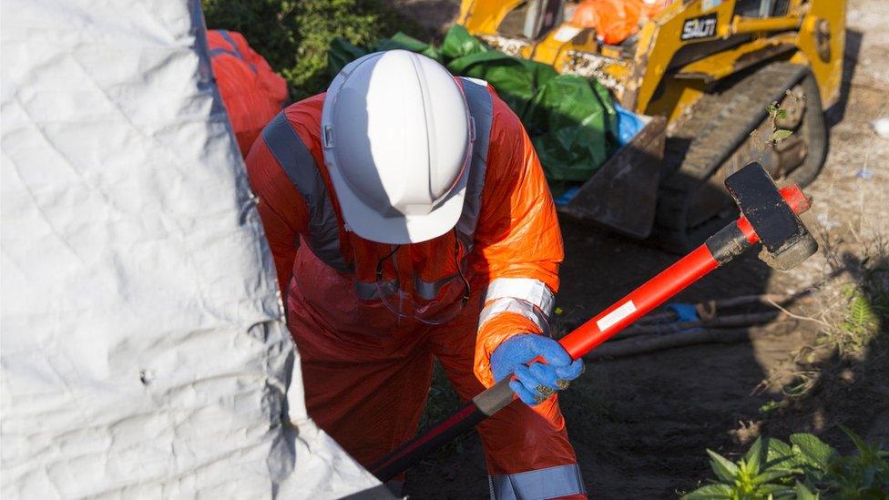 Demolition workers at Calais migrant camp