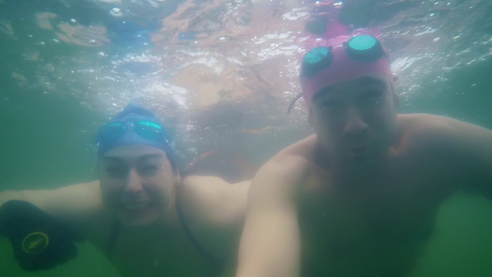 Sarah and Chris van Tulleken swimming under water