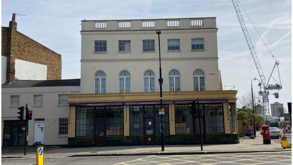 Exterior of the York & Albany pub. Parts of the windows have been boarded up.