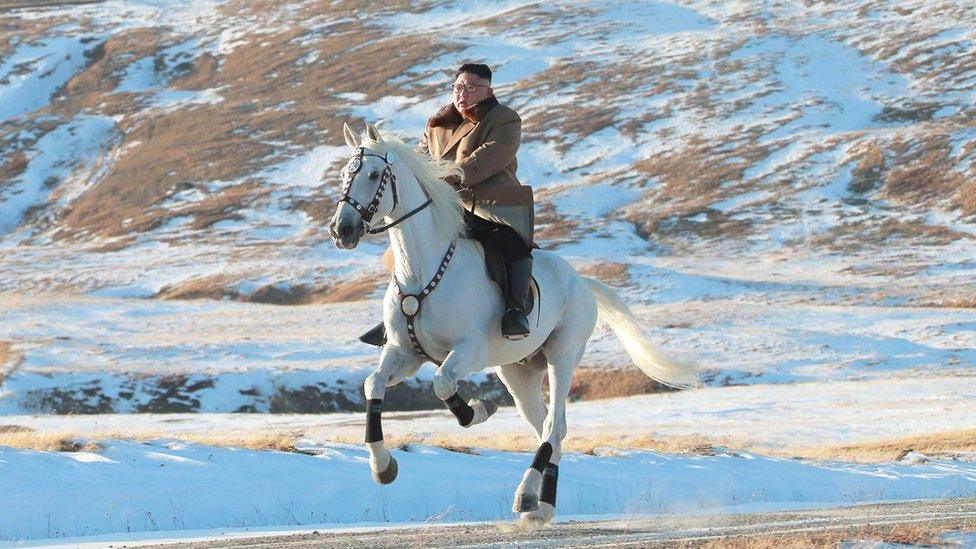 This undated picture released by Korean Central News Agency on October 16, 2019, shows North Korean leader Kim Jong-un riding a white horse amongst the first snow at Mouth Paektu