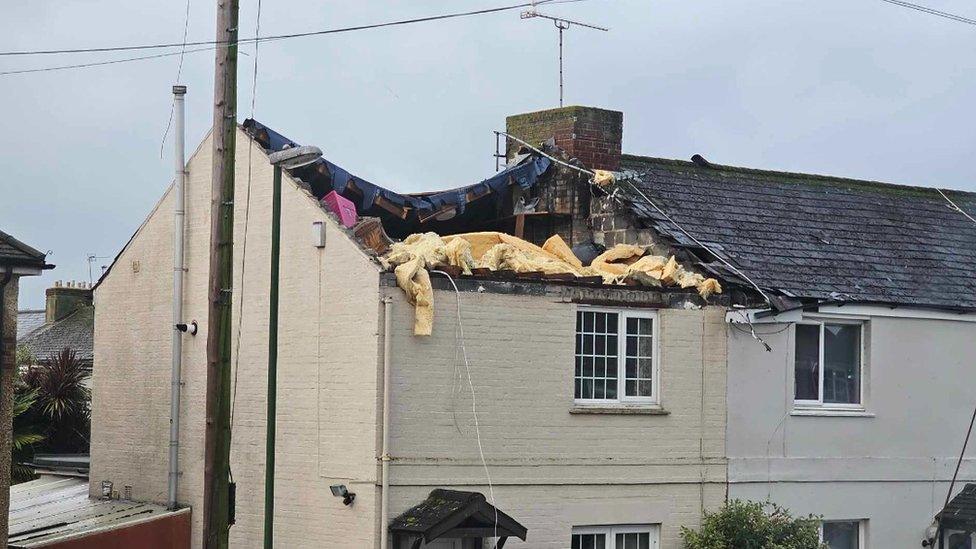 House with roof torn off