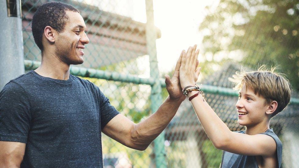 man and boy high fiving