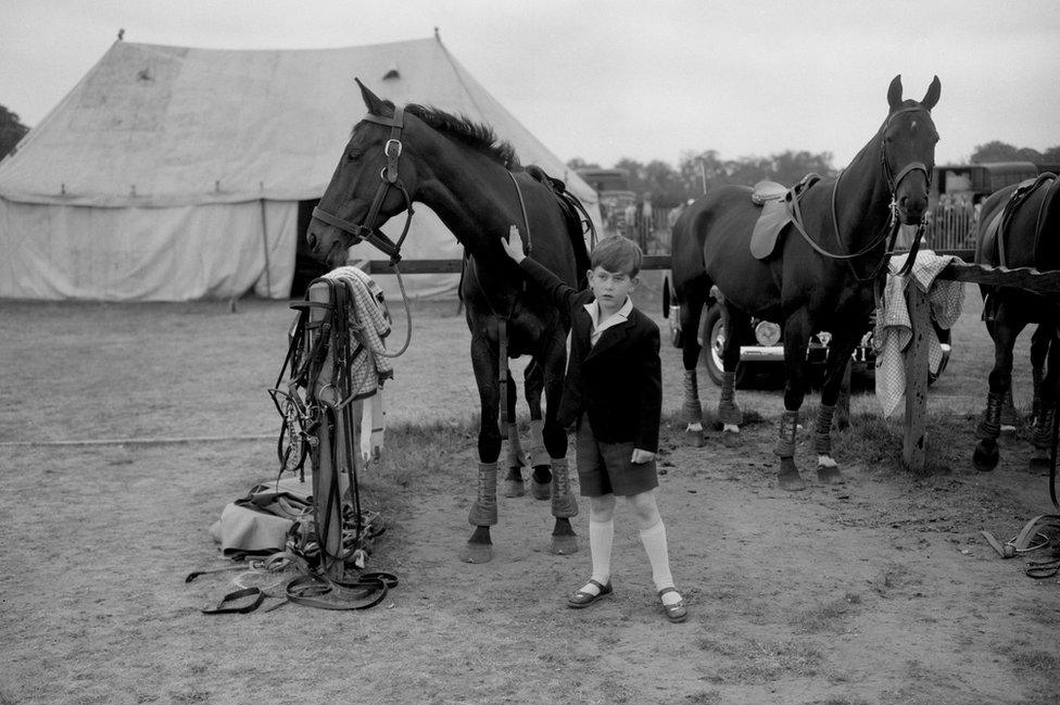 Prince Charles giving a friendly pat to one of the ponies