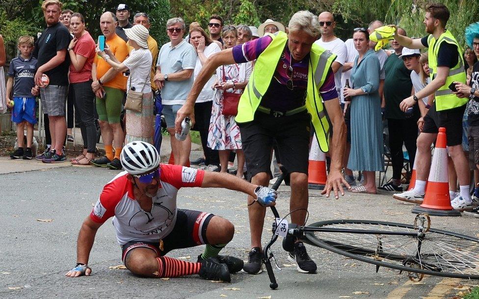 volunteer rushes to help rider who has fallen