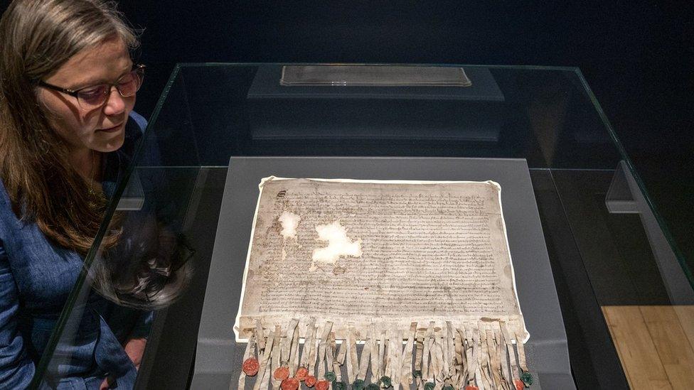 Woman standing next to Declaration of Arbroath