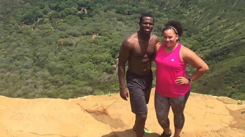 Keenan and Jazzy Owens standing on a hill overlooking trees