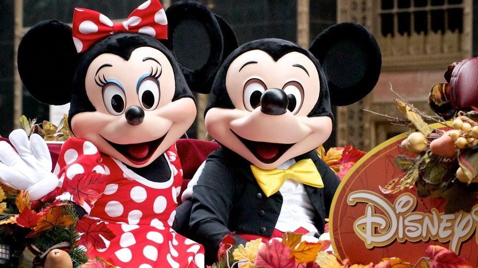 Minnie and Mickey Mouse on a Disney Parks float