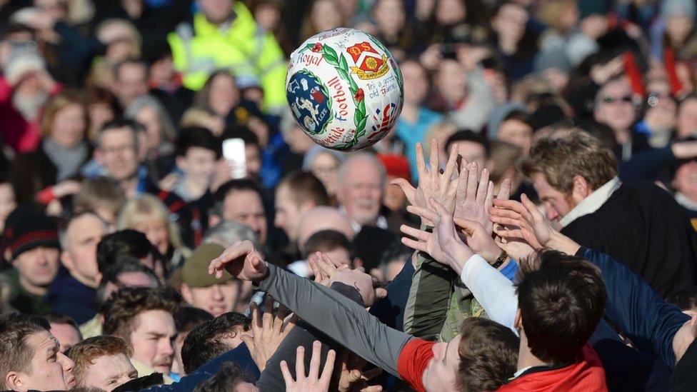 People reach for the ball in Shrovetide football