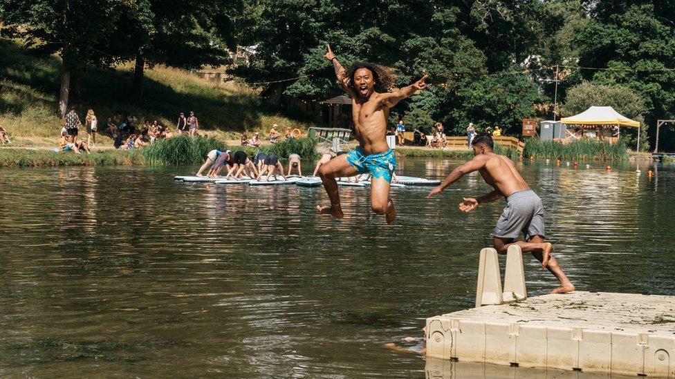 Man jumping into lake