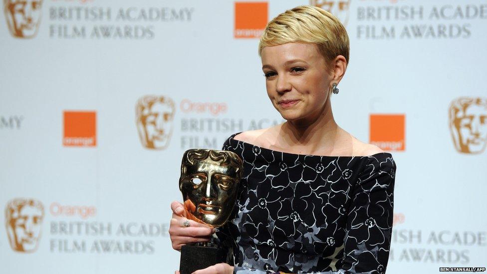 Carey Mulligan holding her BAFTA award