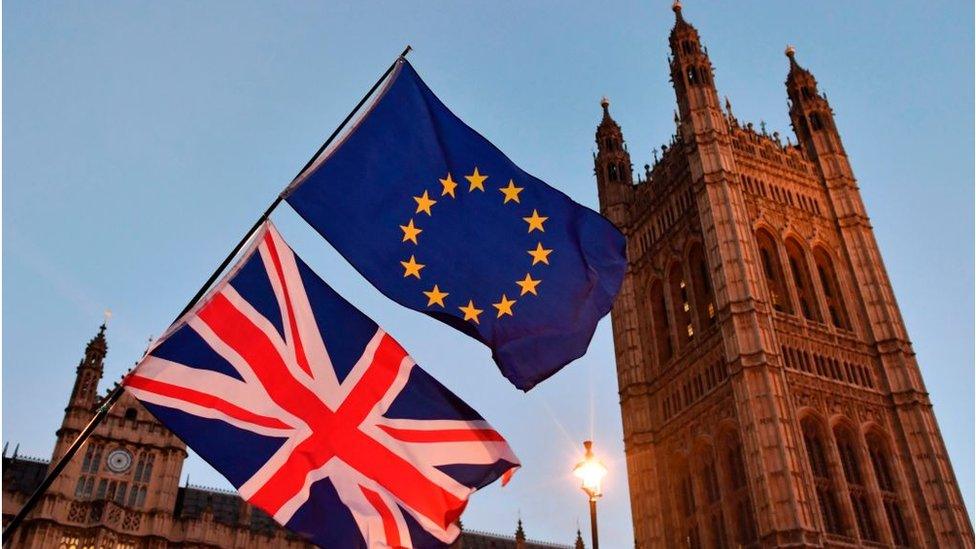 UK and EU flags at the Houses of Parliament