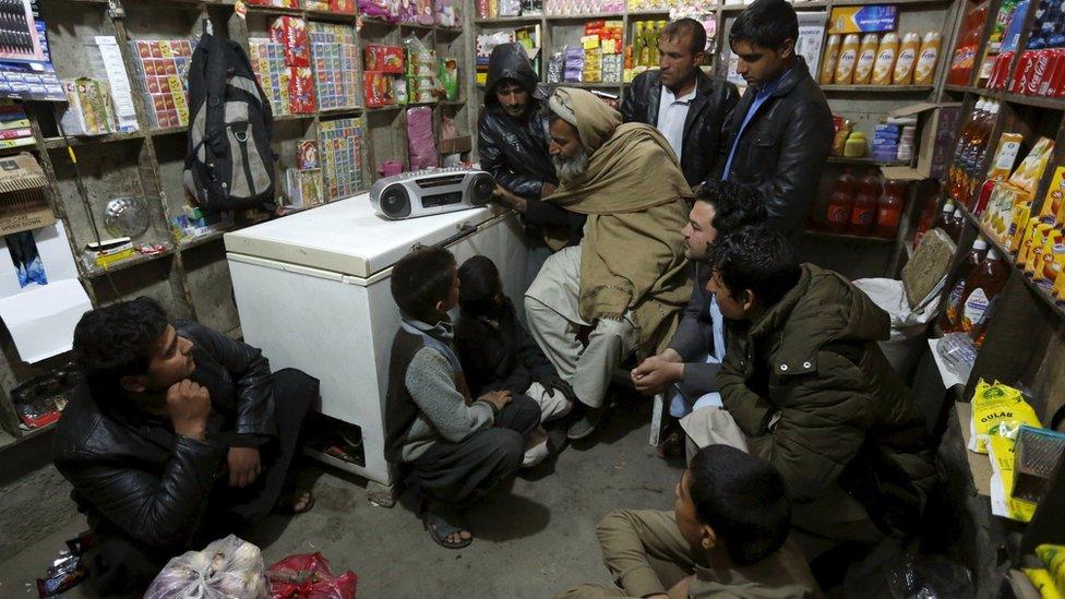 Afghans listen to a radio broadcast run by the Islamic State militants, in the eastern city of Jalalabad, Afghanistan December 19, 2015