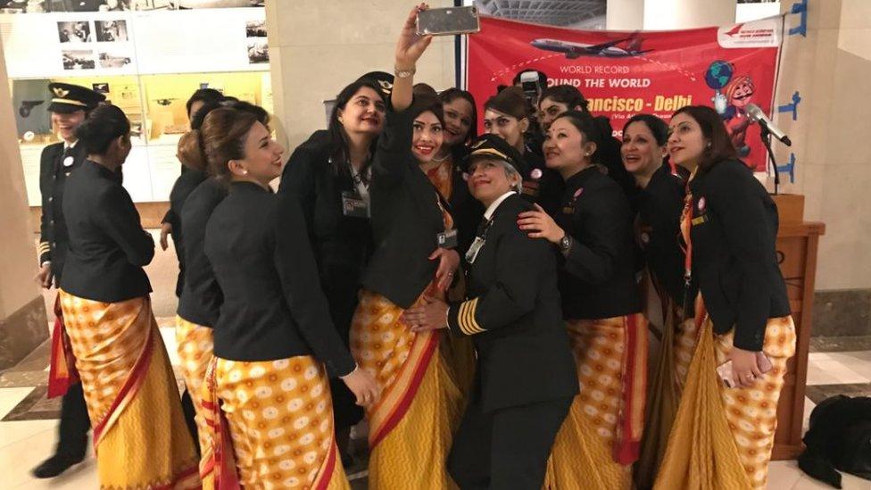 The all-women crew takes pictures at San Francisco Airport