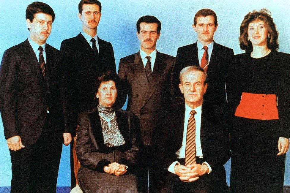 Syrian President Hafez al-Assad (below right) and his wife Anisa Makhlouf (below left) posing for a family picture with his children (L to R) Maher, Bashar, Basil, Majd and Bushra