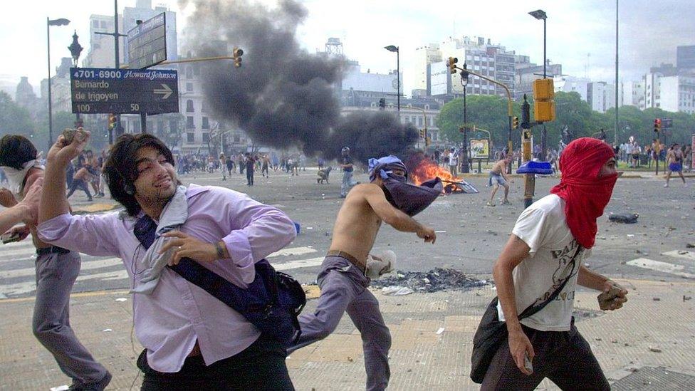 Protesters throw stones at police during the height of Argentina's economic crisis on 20 December 2001