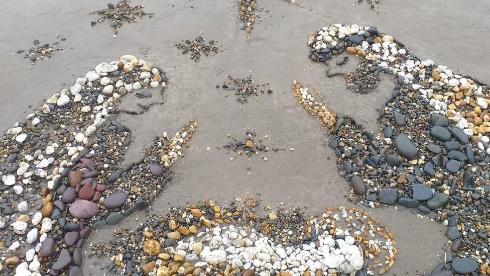 Beach art showing Mary and Joseph