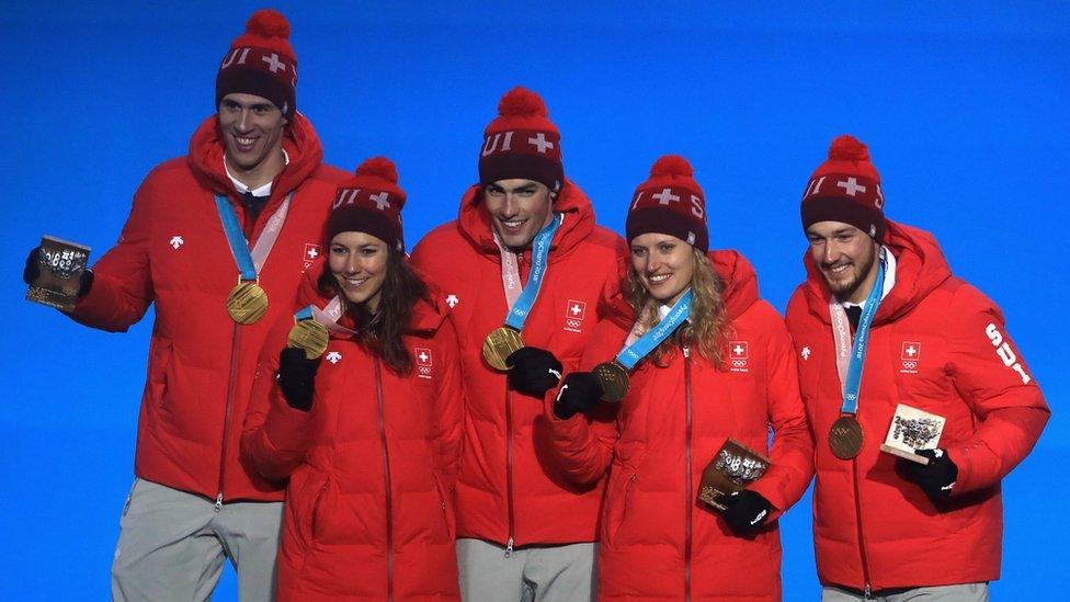 Gold medal winners team Switzerland celebrate during the medal ceremony for the Alpine Team Event at the Winter Olympics