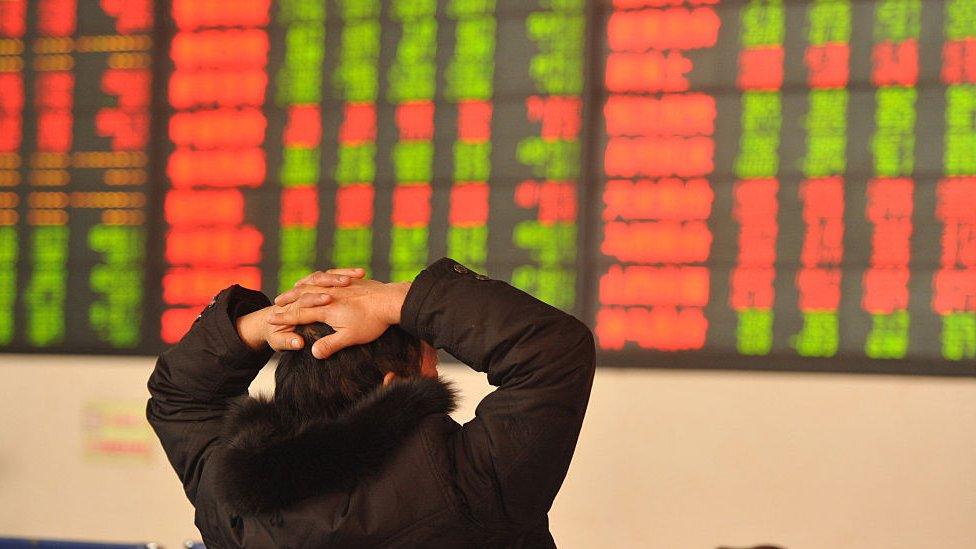 An investor observes the stock market at an exchange hall on January 13, 2016 in Fuyang, Anhui Province of China.