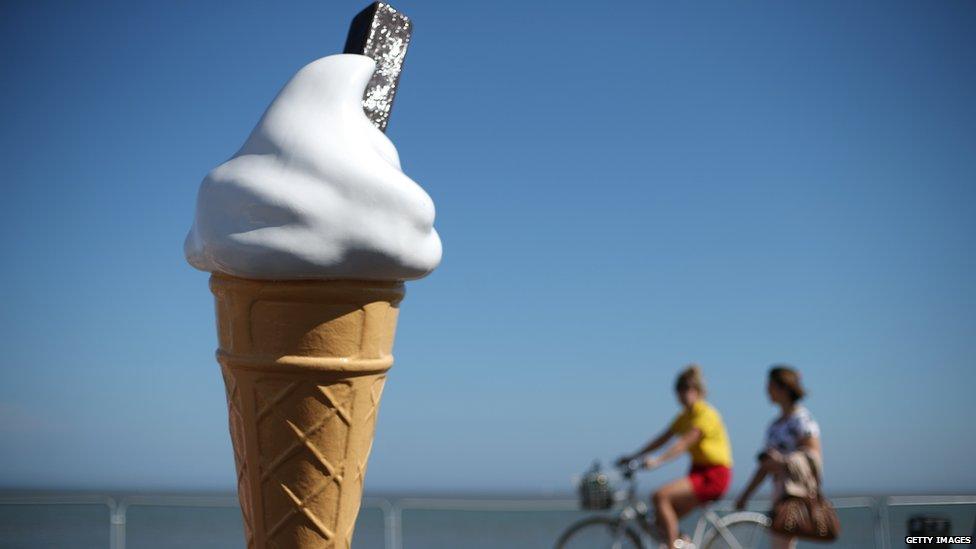 Ice cream cone model with cyclists going past 17 July 2014