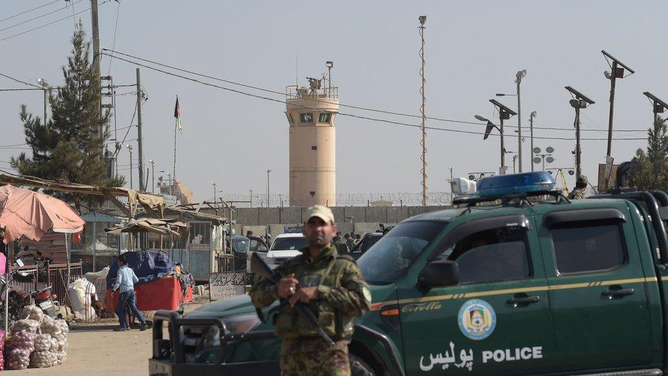 An Afghan security personnel keeps watch near the largest US military base in Bagram, 50 km north of Kabul, after an explosion on November 12, 2016.