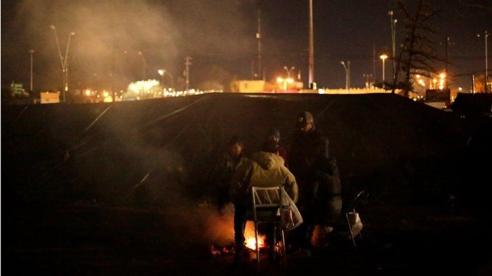 A Mexican family waits to apply for asylum outside their tents as temperatures dropped below freezing in Ciudad Juarez