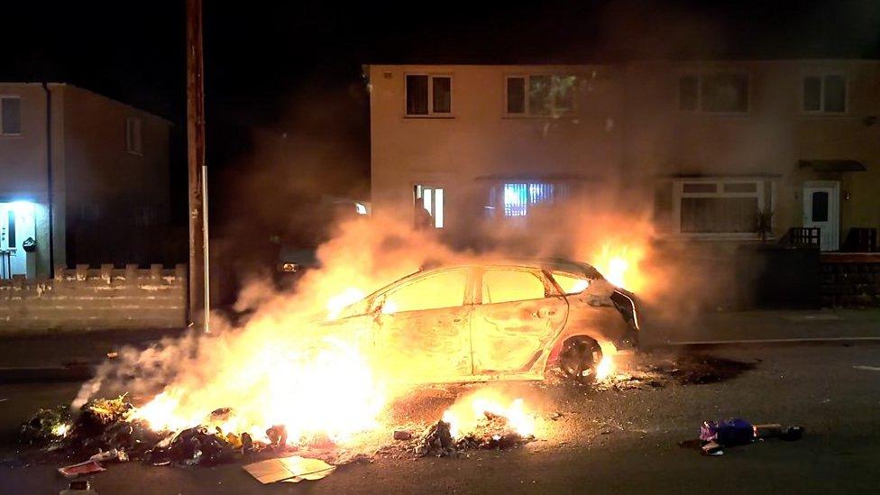 Car burning on street