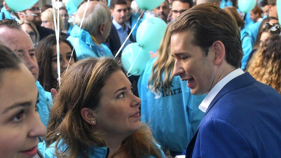 Sebastian Kurz talks to a party supporter in Vienna on 27 September