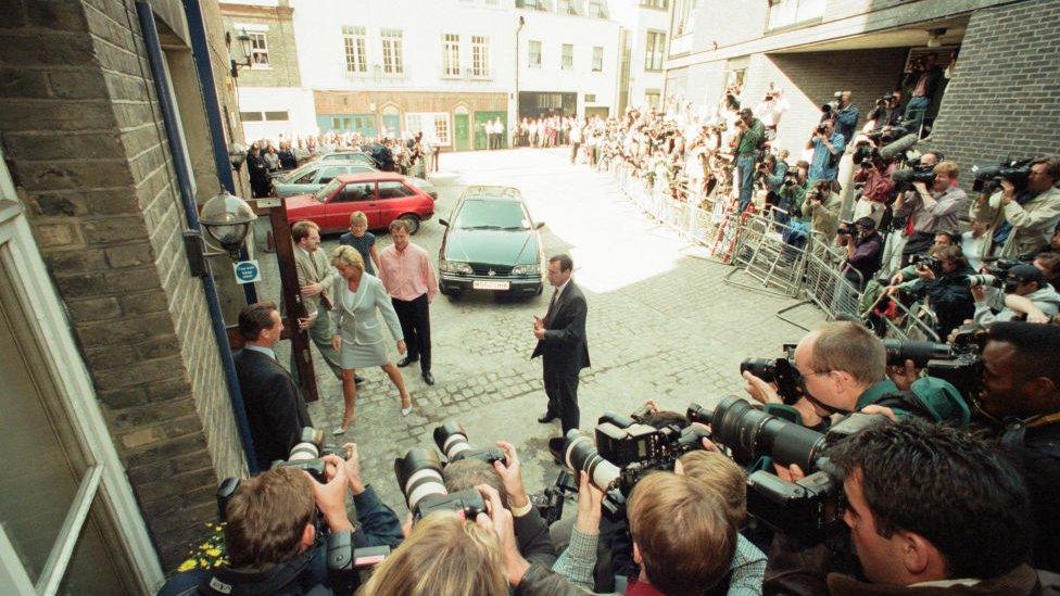 Diana with lots of photographers taking picture of her